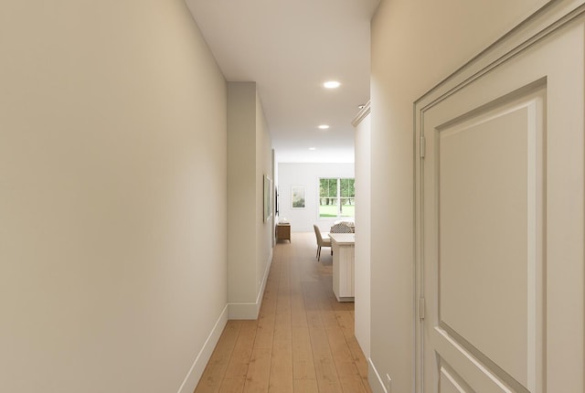 corridor featuring recessed lighting, light wood-style flooring, and baseboards
