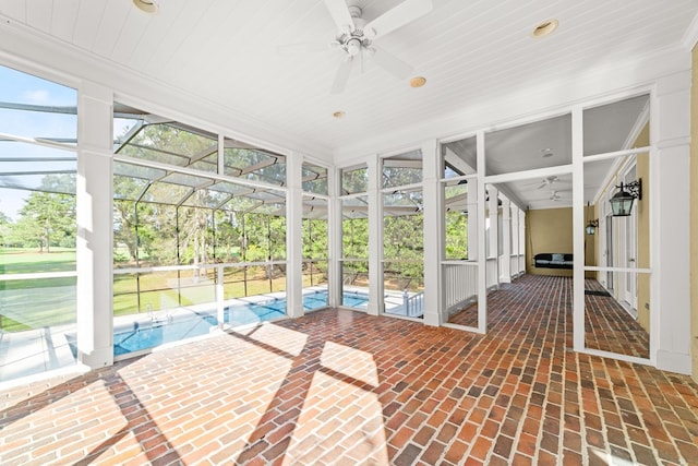 unfurnished sunroom featuring a swimming pool, wood ceiling, a wealth of natural light, and ceiling fan