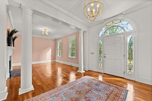 foyer featuring an inviting chandelier, crown molding, and hardwood / wood-style flooring