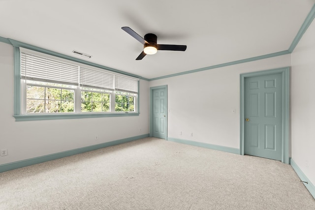 unfurnished bedroom featuring light carpet, crown molding, and ceiling fan