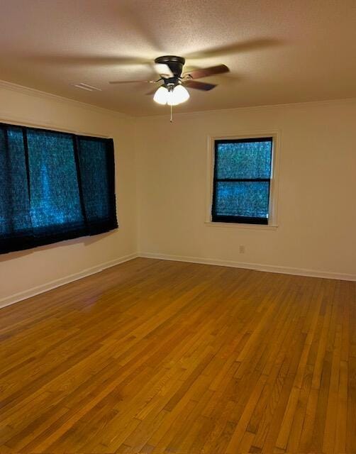 unfurnished room with ceiling fan, baseboards, and wood finished floors