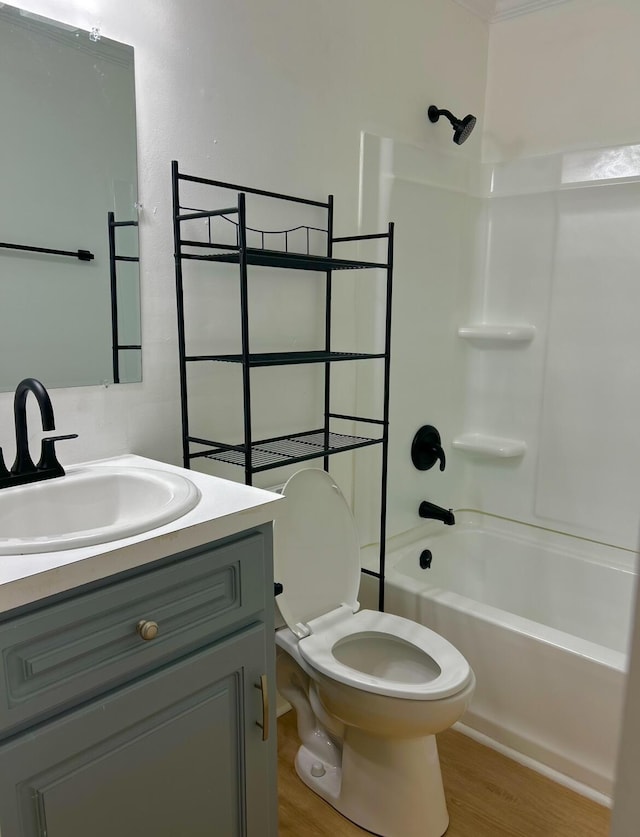 full bathroom featuring toilet, wood finished floors, vanity, and shower / bathtub combination