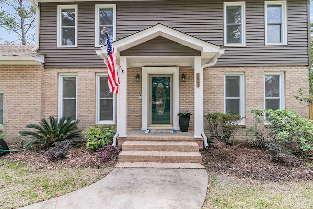property entrance featuring brick siding