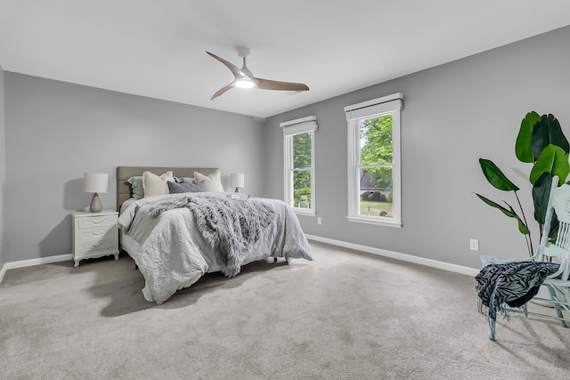 bedroom with ceiling fan, carpet flooring, and baseboards