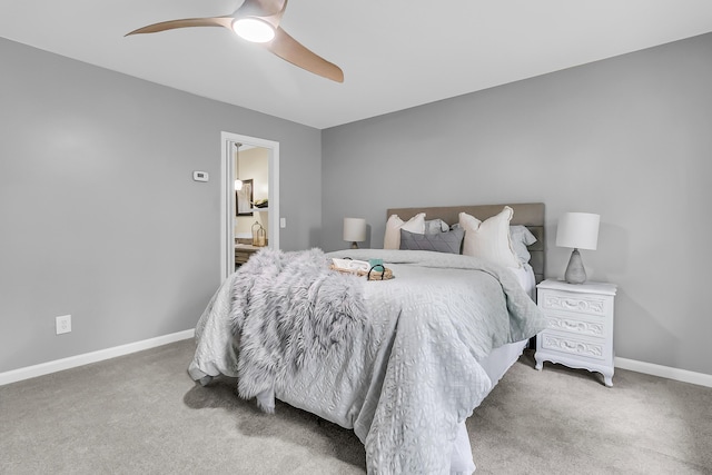 bedroom featuring a ceiling fan, carpet flooring, connected bathroom, and baseboards