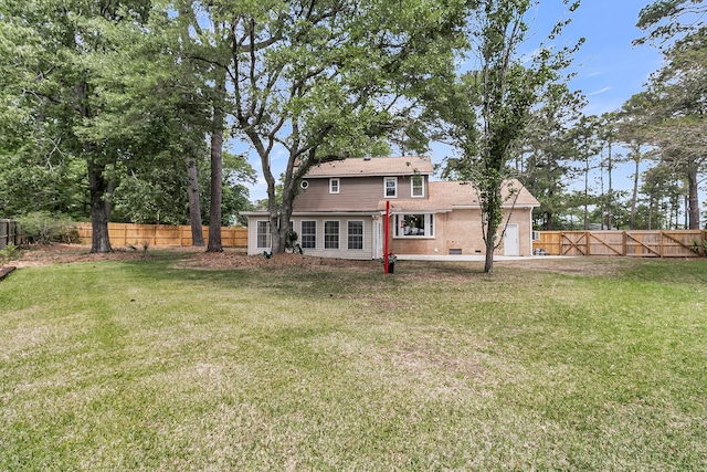 back of property featuring brick siding, a fenced backyard, and a lawn