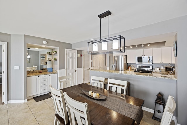 tiled dining room with sink