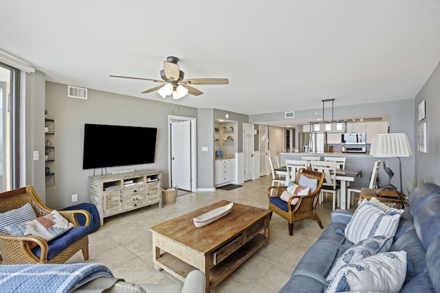 living room featuring light tile patterned floors and ceiling fan