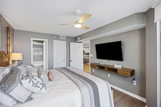 bedroom featuring ceiling fan, hardwood / wood-style floors, and ensuite bath