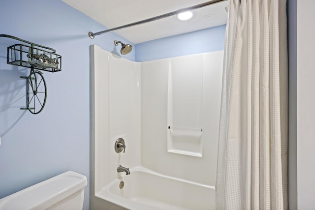 bathroom with shower / tub combo and toilet