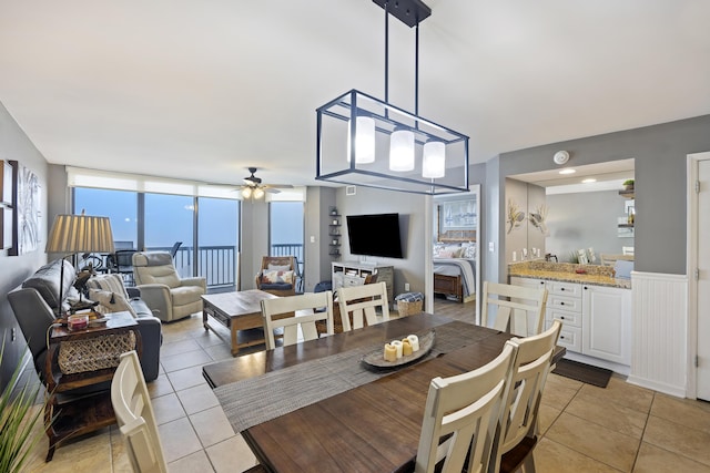 tiled dining space featuring ceiling fan