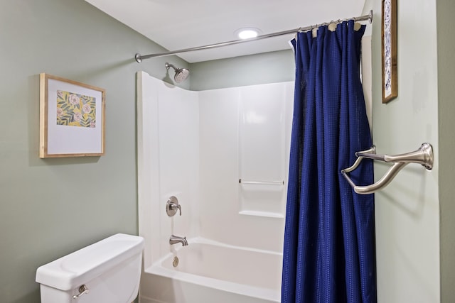 bathroom featuring shower / bath combination with curtain and toilet