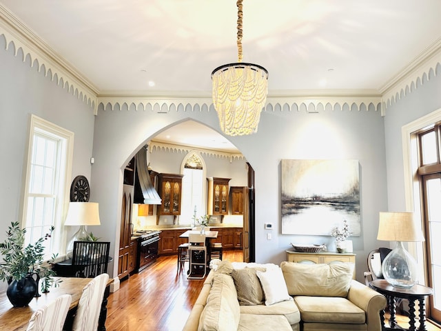174 N Shelmore Blvd, Mount Pleasant, SC 29464 - living room with a chandelier, arched walkways, light wood-type flooring, and ornamental molding