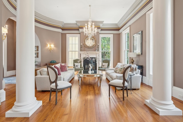 174 N Shelmore Blvd, Mount Pleasant, SC 29464 - living room with arched walkways, ornate columns, a chandelier, light wood-style flooring, and ornamental molding