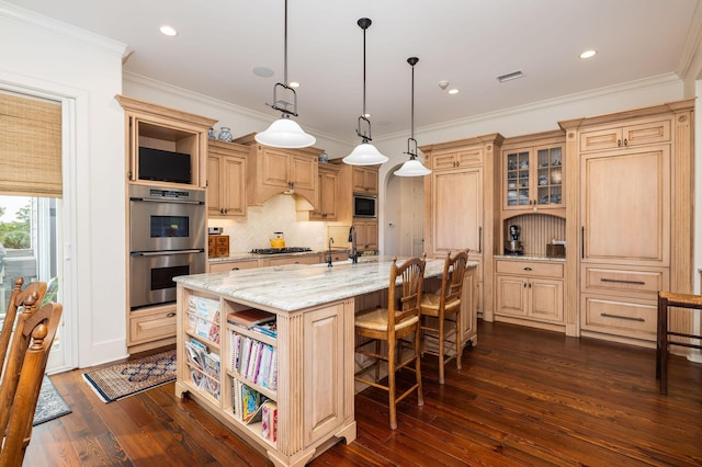 kitchen featuring hanging light fixtures, stainless steel appliances, light stone counters, dark hardwood / wood-style flooring, and a kitchen island with sink