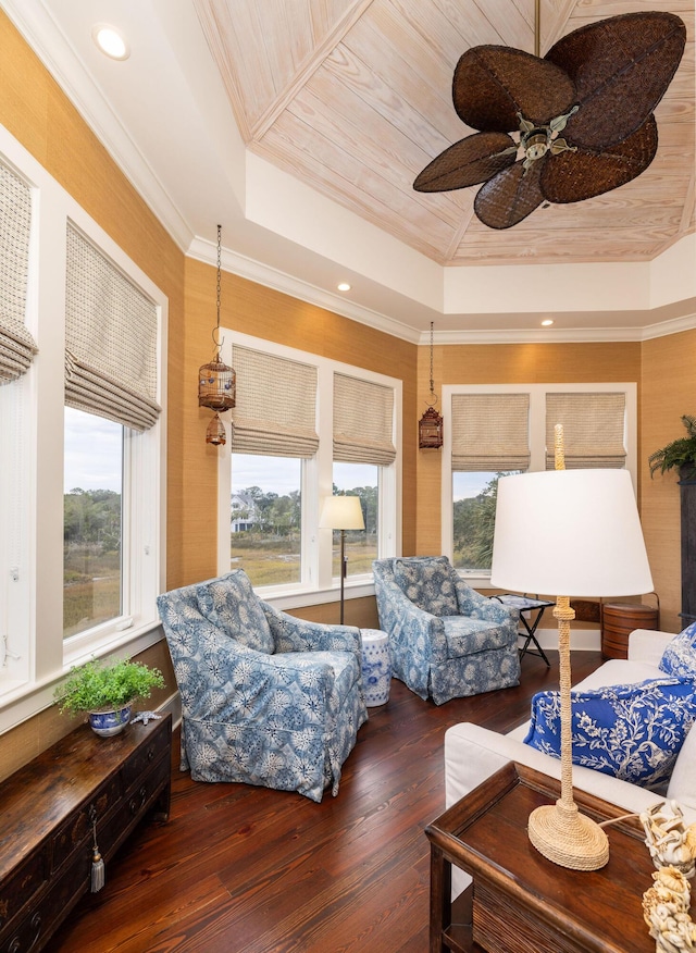 living room with a tray ceiling, crown molding, ceiling fan, and hardwood / wood-style flooring