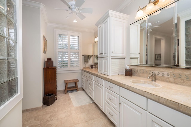 bathroom featuring ceiling fan, vanity, and ornamental molding