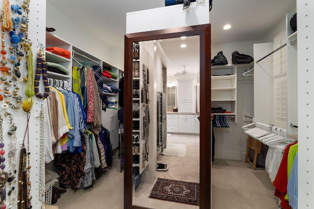 walk in closet featuring light carpet