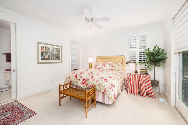 carpeted bedroom with ensuite bath, ceiling fan, and ornamental molding