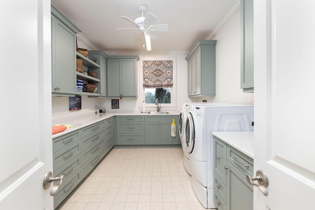 laundry area with cabinets, ornamental molding, ceiling fan, sink, and independent washer and dryer