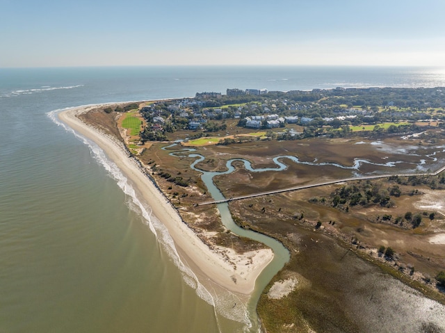 birds eye view of property with a water view and a beach view