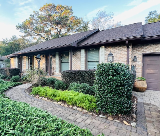 1039 Grand Concourse St, Charleston, SC 29412 - view of property exterior featuring brick siding and roof with shingles