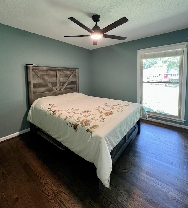 1039 Grand Concourse St, Charleston, SC 29412 - bedroom featuring dark wood finished floors, ceiling fan, baseboards, and a textured ceiling