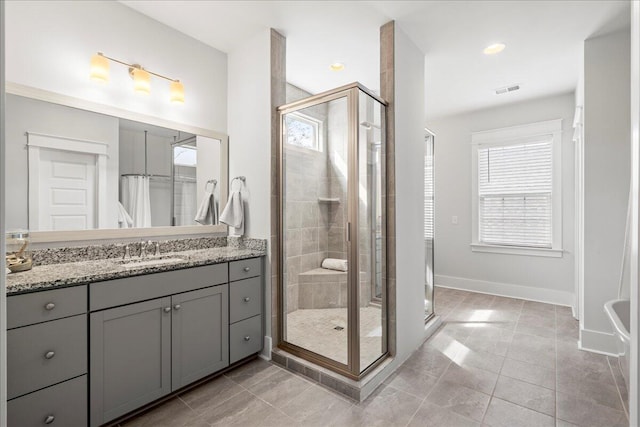 bathroom featuring vanity, tile patterned floors, and a shower with door