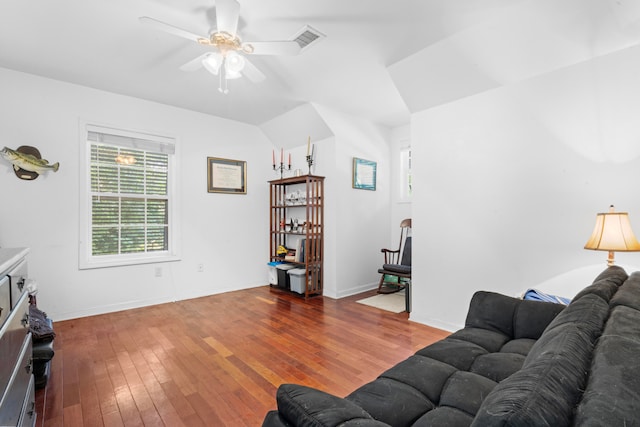 living room with ceiling fan, lofted ceiling, and hardwood / wood-style flooring