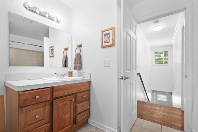 bathroom featuring vanity, tile patterned floors, and ornamental molding