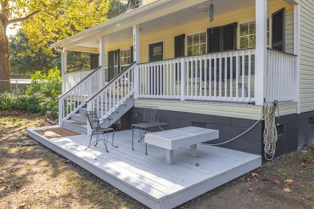 wooden terrace featuring covered porch