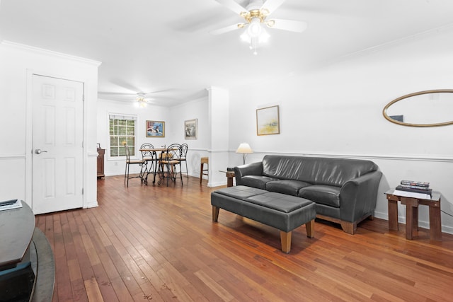 living room with ceiling fan, crown molding, and hardwood / wood-style flooring