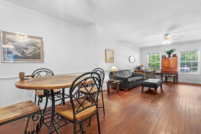 dining space featuring hardwood / wood-style floors, ceiling fan, and crown molding