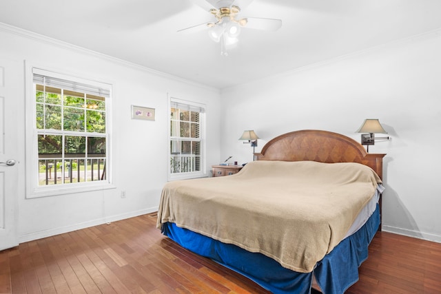 bedroom featuring ceiling fan, dark hardwood / wood-style flooring, and crown molding