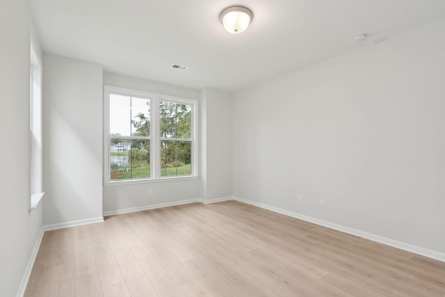 spare room featuring light wood-type flooring