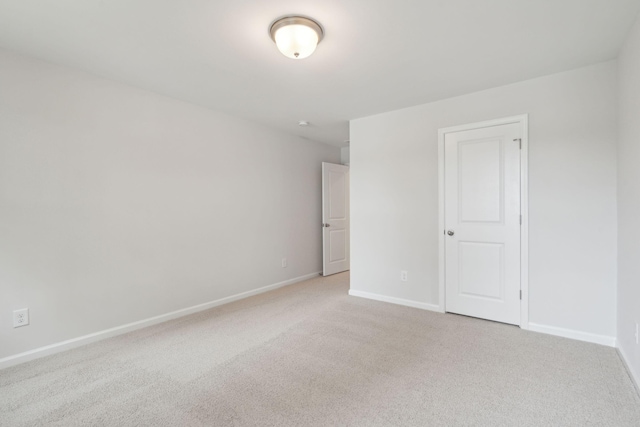 unfurnished room with light colored carpet