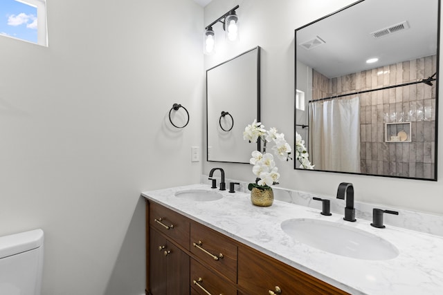 full bath featuring visible vents, a sink, and toilet