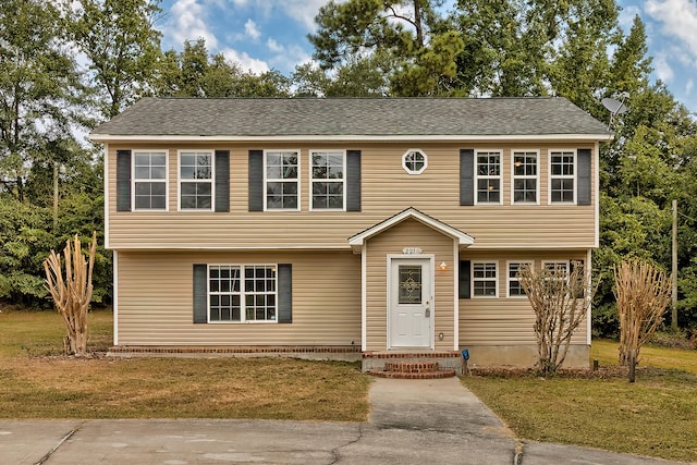 colonial home with a front lawn