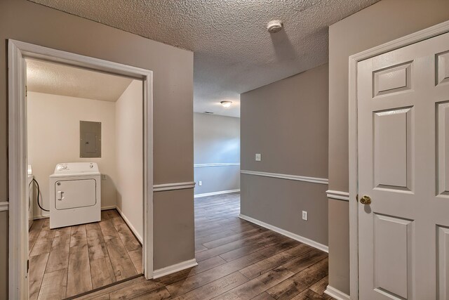 empty room with a textured ceiling and dark hardwood / wood-style floors