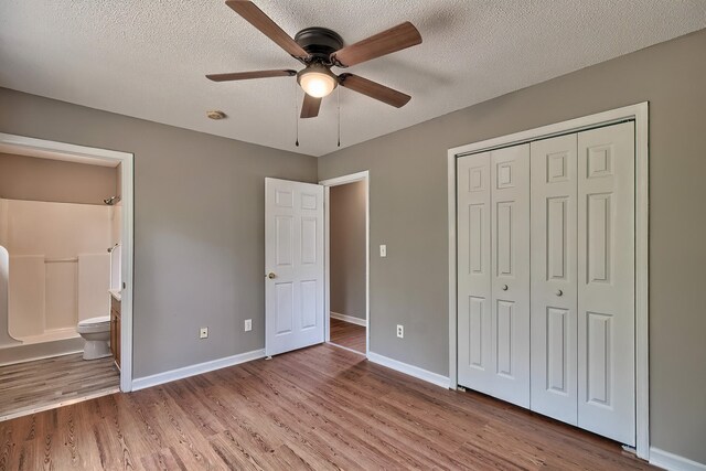 empty room with a textured ceiling, ceiling fan, and hardwood / wood-style floors