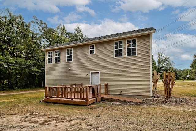 rear view of property with a lawn and a wooden deck