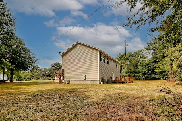 view of side of home featuring a yard, cooling unit, and a wooden deck