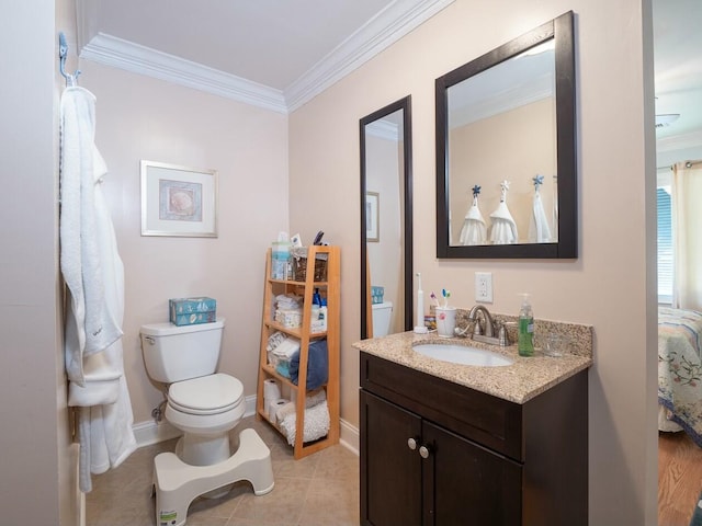 bathroom with tile patterned floors, toilet, vanity, and ornamental molding