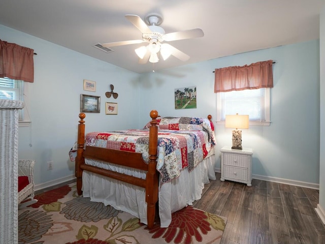 bedroom with dark hardwood / wood-style floors and ceiling fan