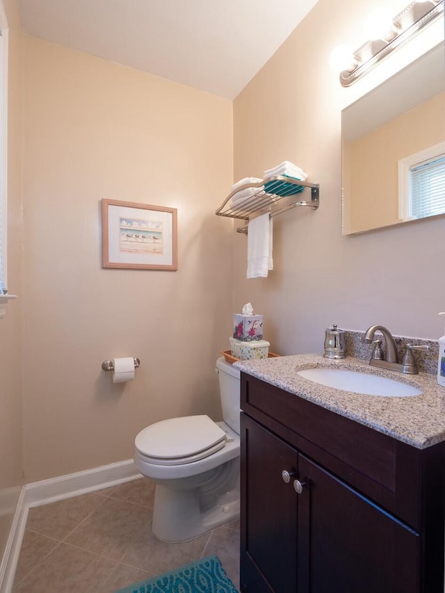 bathroom featuring tile patterned floors, vanity, and toilet