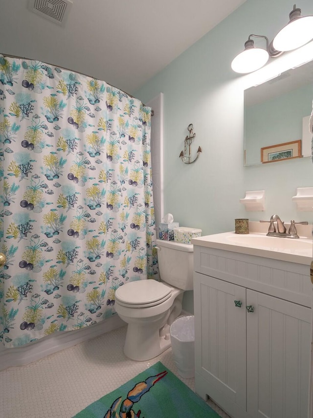 bathroom with walk in shower, vanity, and toilet