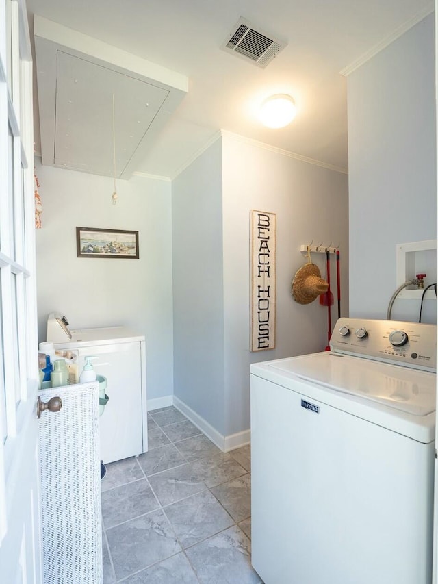 laundry area featuring washer / dryer and crown molding