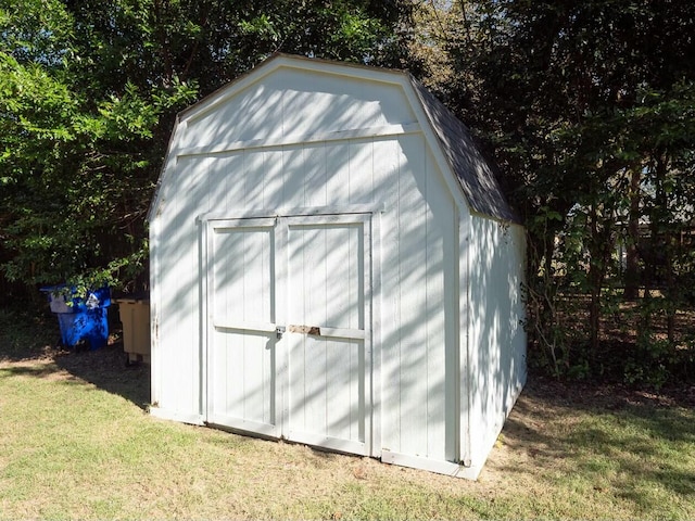 view of outdoor structure featuring a lawn