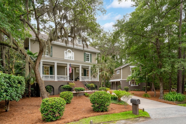 1612 John Fenwick Ln, Johns Island, SC 29455 - view of front facade featuring covered porch, driveway, and stairway