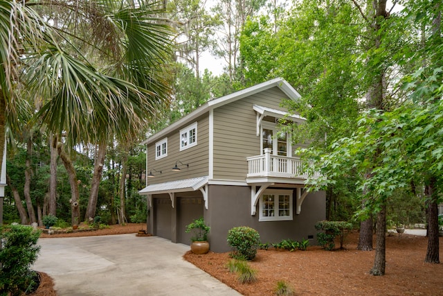 1612 John Fenwick Ln, Johns Island, SC 29455 - view of front of property with a balcony, driveway, stucco siding, and a garage